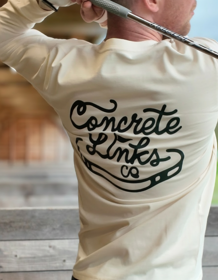 Person wearing a white long-sleeve shirt with 'Concrete Links' logo and text, holding a golf club.